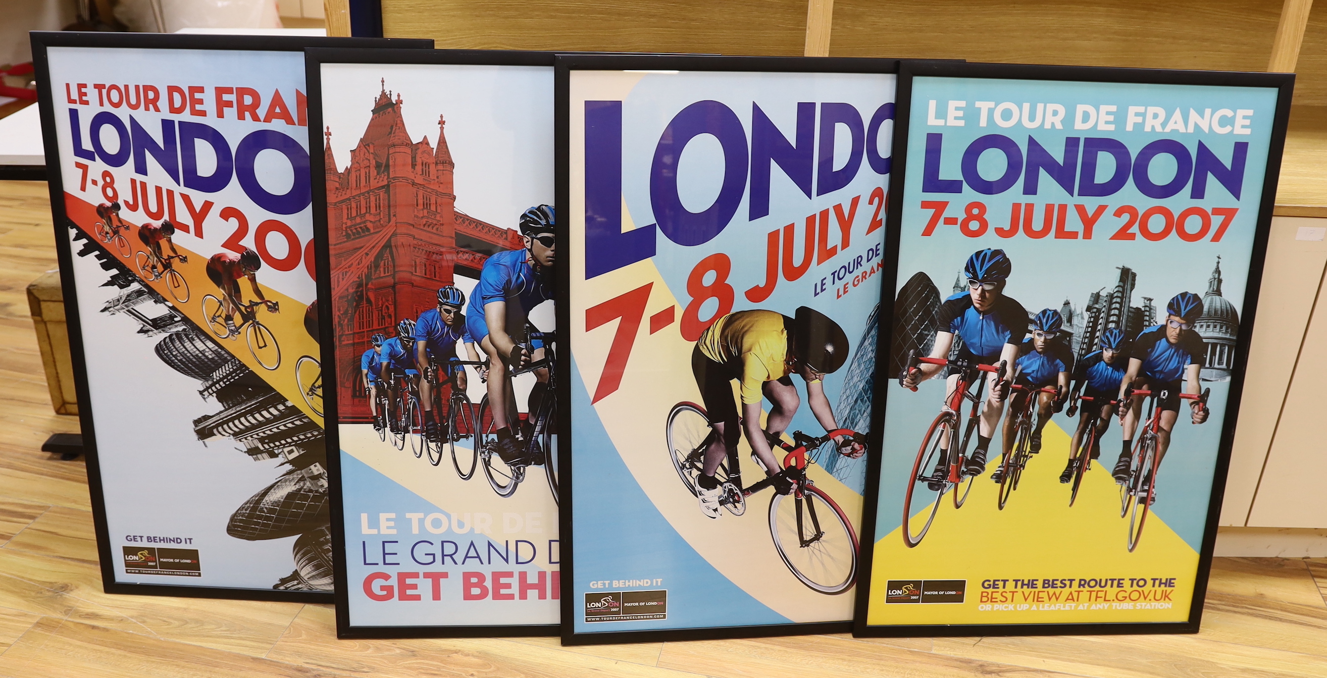 A set of four Tour De France posters, framed